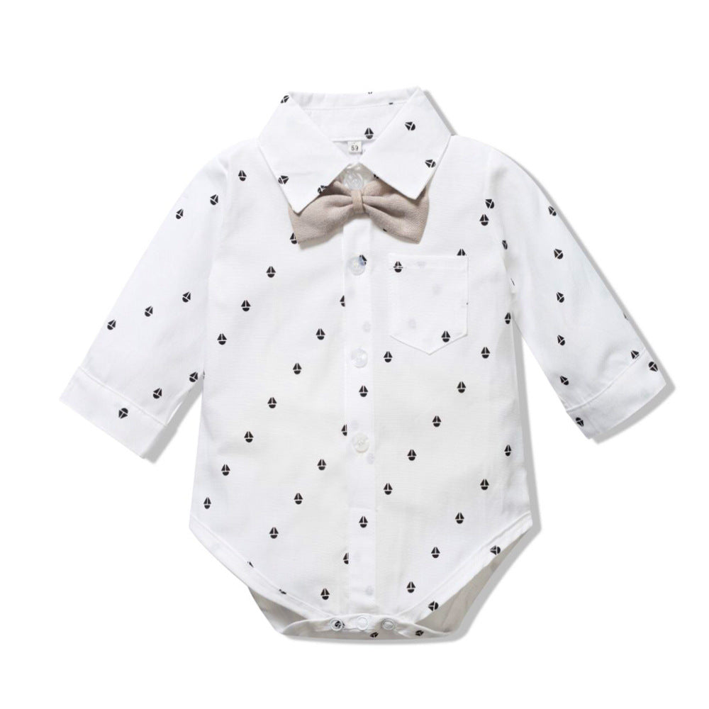 White baby bodysuit with black polka dots and a beige bow tie on a white background