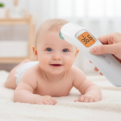 Baby lying on a white blanket with a digital thermometer being held above its head.